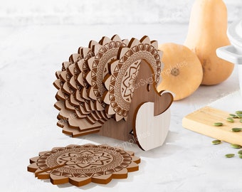 May include: A set of eight wooden coasters with a mandala design. The coasters are stacked in a holder shaped like a turkey. The coasters are brown and have a natural wood finish.
