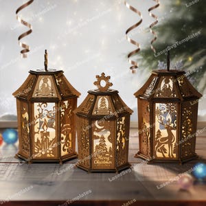 May include: Three wooden Christmas lanterns with intricate cut-out designs. The lanterns feature festive scenes including a snowman, a deer, and a Christmas tree. The middle lantern has the text "Merry Christmas". Each lantern has a unique top design.