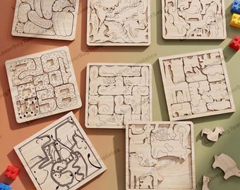 May include: A collection of wooden jigsaw puzzles featuring various themes. The puzzles include vegetable shapes, animal figures, and number patterns. Each puzzle is made of light-colored wood and has a square frame. Some puzzles are partially assembled.