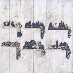 May include: Six different corner designs for a winter-themed craft project. Each design features a different winter scene, including a snowman, a deer, a Christmas village, a Santa Claus, and snowflakes. The designs are cut from wood and are ready to be painted or stained.