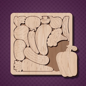 May include: A wooden cutout puzzle featuring various vegetables, including a bell pepper, onion, carrot, aubergine, broccoli, and mushrooms. The puzzle pieces are arranged in a square shape on a wooden background.