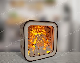 May include: A wooden Easter night light with a square shape. The light features a cut-out design of bunnies, eggs, and flowers. The words "Happy Easter" are visible in the center of the design. The light is illuminated from within, creating a warm glow.