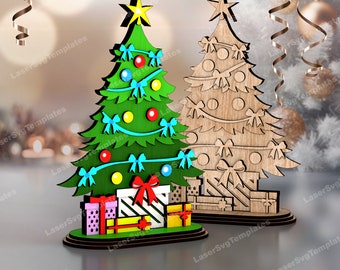 May include: Two wooden Christmas tree ornaments, one decorated with green, blue, and red ornaments and the other with a natural wood finish. Both trees have a star on top and are decorated with presents at the base.