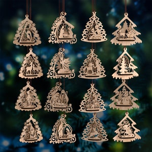 May include: A collection of wooden Christmas ornaments in various shapes, including trees and stylized shapes. Each ornament features intricate cut-out designs depicting Nativity scenes, angels, and other holiday figures. The ornaments are suspended by brown strings.