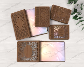 May include: Several wooden wedding guest books with intricate laser-cut designs are displayed. The books are open and closed, showcasing various patterns and personalized details. The text "Michael & Angelina 24.08.24" is visible on some of the books.