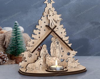May include: A wooden Christmas tree-shaped candle holder with a nativity scene. The laser-cut design features Mary, Joseph, baby Jesus, an angel, a star, and animals. A lit tea light candle sits in the center, illuminating the scene.