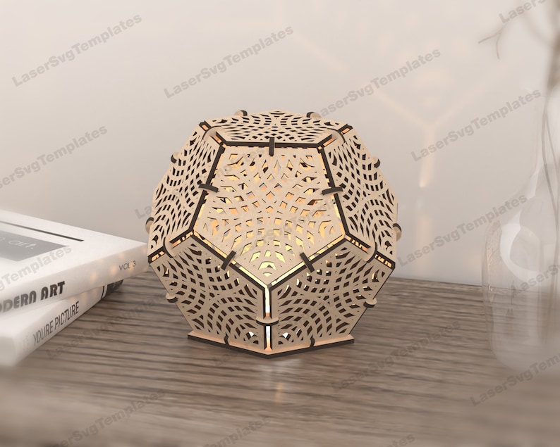 May include: A wooden geometric lampshade with a intricate laser cut design. The lampshade is a light brown color and has a hexagonal shape.