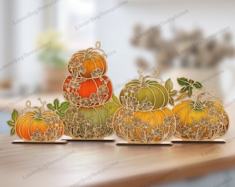 May include: Wooden pumpkin decorations in various sizes and colors, including orange, green, and yellow. Each pumpkin is intricately designed with floral cutouts and rests on a small wooden base, perfect for fall decor.