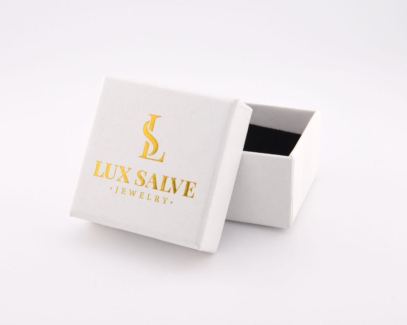 May include: White jewellery box with a gold logo that says "LUX SALVE JEWELLERY".