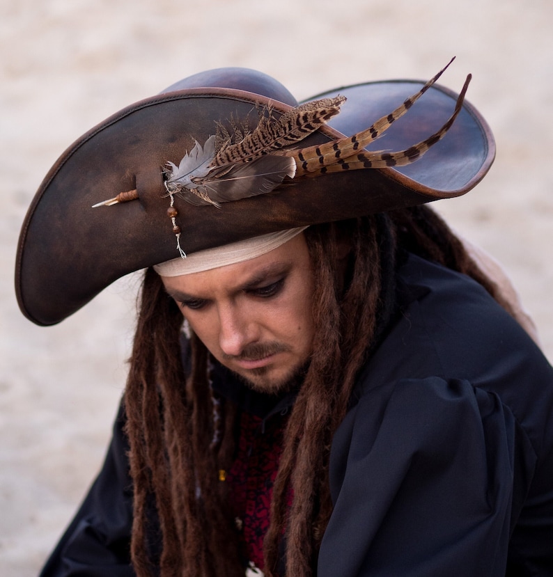 Handmade brown pirate leather hat with wide brim, genuine leather, front view.Pirate leather hat worn on head, cosplay and renaissance style