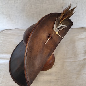 Wide brim pirate leather hat handmade from genuine brown leather, angled view