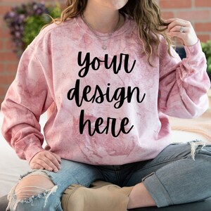 Może przedstawiać: Różowa bluza tie-dye z napisem "your design here" czarnymi literami.