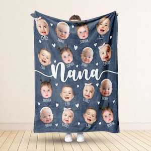 May include: A blue fleece blanket with white hearts and the word 'Nana' in white cursive. There are 16 photos of babies on the blanket, each with a name below: Emily, Noah, Sophia, Leo.