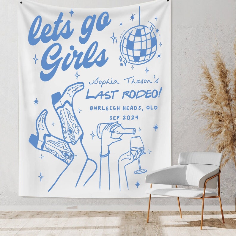 May include: A white tapestry with blue text that reads "lets go Girls Sophia Thoson's LAST RODEO! BURLEIGH HEADS, QLD SEP 2024". The tapestry also features a blue disco ball, a blue wine glass, and a blue bottle of wine.