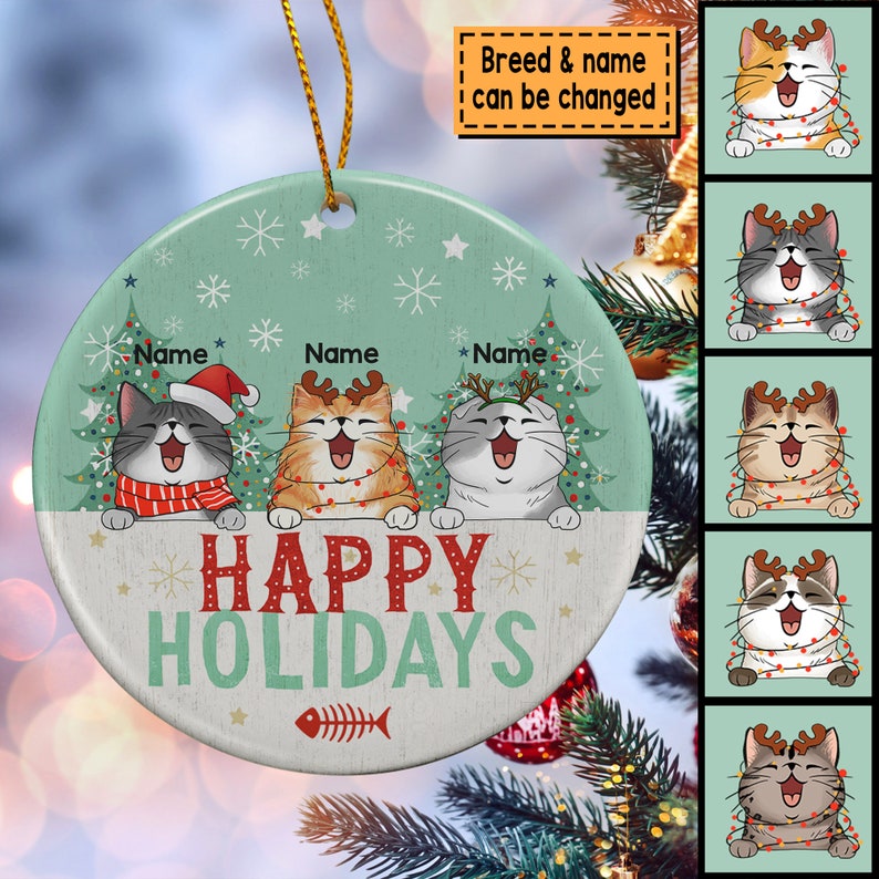 May include: A round, green and white Christmas ornament with three cats wearing Santa hats and reindeer antlers. The ornament says "Happy Holidays" and has a fishbone design. The breed and name of the cats can be changed.
