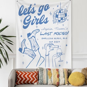 May include: A white banner with blue text and illustrations. The text reads "lets go Girls Sophia Thoson's LAST RODEO! BURLEIGH HEADS, QLD SEP 2024". The banner features a disco ball, two pairs of cowboy boots, and a hand holding a glass of wine.