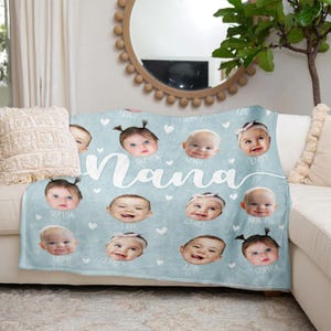 May include: A light blue fleece blanket with the word "Nana" printed in white. The blanket features a collage of 10 baby photos with each baby's name printed below their photo.