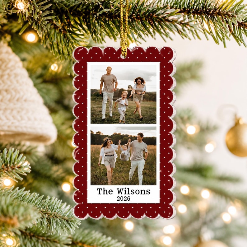 May include: A rectangular Christmas ornament with a scalloped edge, featuring a deep red border with white polka dots. The center displays two stacked photographs of a family in a field, with the text The Wilsons 2026 printed at the bottom.