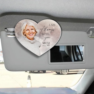 May include: A heart-shaped car visor clip with a watercolor background and a photo of a woman. The text reads "I am Always With You Mom 1952-2024".