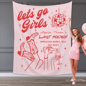 May include: Pink bachelorette party banner with the text "lets go girls" in red cursive font. A disco ball, cowboy boots, and a hand holding a wine glass are illustrated in red. The text "Sophia Thoson's Last Rodeo! Burleigh Heads, QLD SEP 2024" is also in red.
