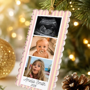 May include: A rectangular acrylic ornament with scalloped edges and a light pink and yellow vertical striped border. It features three stacked photos: an ultrasound, a baby with a pacifier, and a young girl. The name Amelia Smith and 2026 are printed.