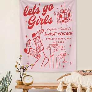May include: Pink tapestry with the text "lets go Girls" in red. A disco ball and a pair of cowboy boots are also depicted. The text "Sophia Thoson's LAST RODEO! BURLEIGH HEADS, QLD SEP 2024" is also included.