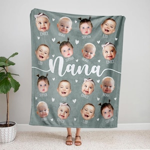 May include: A gray fleece blanket with a white heart pattern and the word "Nana" in white cursive. There are 14 photos of babies on the blanket, each with a name underneath: Emily, Noah, Sophia, Leo, Sophia, Noah, Emily, Sophia, Leo, Emily, Noah, Emily, Leo, Sophia.