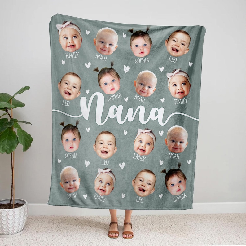 May include: A gray fleece blanket with a white heart pattern and the word "Nana" in white cursive. There are 14 photos of babies on the blanket, each with a name underneath: Emily, Noah, Sophia, Leo, Sophia, Noah, Emily, Sophia, Leo, Emily, Noah, Emily, Leo, Sophia.