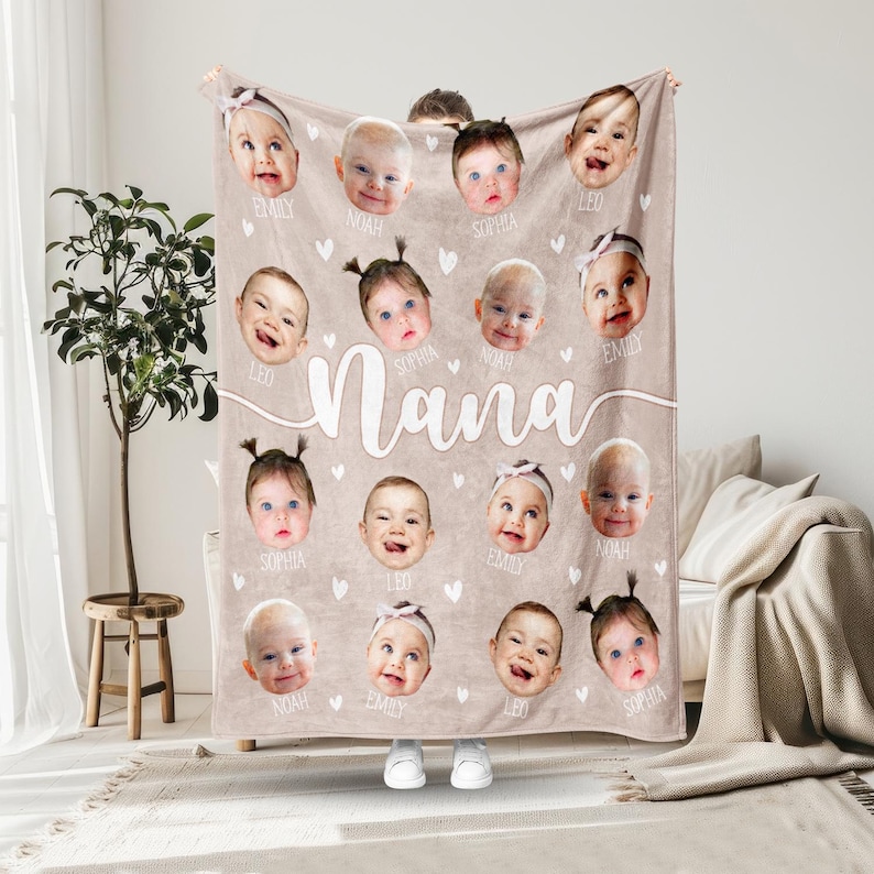 May include: A beige fleece blanket with a white heart pattern and the word "Nana" printed in white. The blanket features 16 individual photos of babies with their names printed below each photo.
