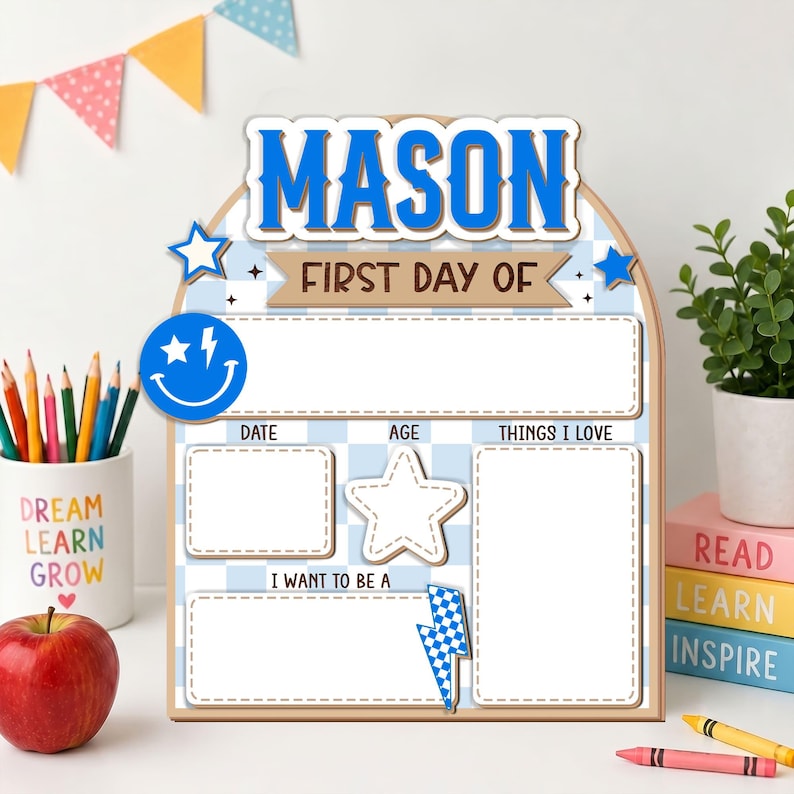 May include: An arched wooden sign with a light blue and white checkered pattern. The text reads MASON FIRST DAY OF. It features blank white sections for date, age, things I love, and future goals, decorated with a blue smiley face and lightning bolt.