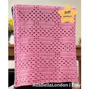 May include: A pink crocheted blanket with a repeating openwork pattern. The blanket is draped over a chair. A yellow star-shaped graphic with the words "pdf pattern" is in the upper right corner. The Etsy shop name "AllaBellaLondon" is at the bottom.