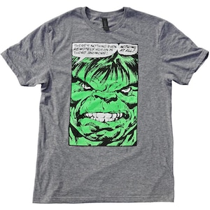 May include: A grey t-shirt featuring a green and black comic book image of the Hulk's face. The image includes a speech bubble that reads "There's nothing even remotely human in there anymore!" and "Nothing at all!"