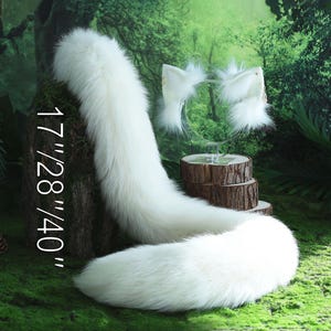 May include: White faux fur tail with a white faux fur headband with cat ears. The tail is 17/28/40 inches long. The tail and headband are on a green mossy surface.