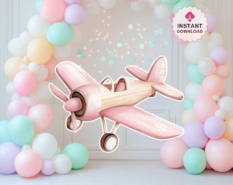 May include: A pink and tan watercolour airplane cutout with a brown propeller and wheels. The airplane is surrounded by a pastel balloon arch in shades of pink, white, mint, and lavender. The image has an "INSTANT DOWNLOAD" graphic.