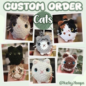 May include: A collection of six round, crocheted cat plushies in various colors including black, white, gray, brown, and calico patterns. Each cat features large plastic eyes, embroidered noses, and white yarn whiskers. The text reads CUSTOM ORDER Cats.