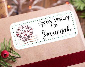 May include: A brown paper gift box with a red ribbon and a white gift tag that says "Special Delivery For: Savannah". The gift tag has a green border and a red and white Santa's Mail stamp.