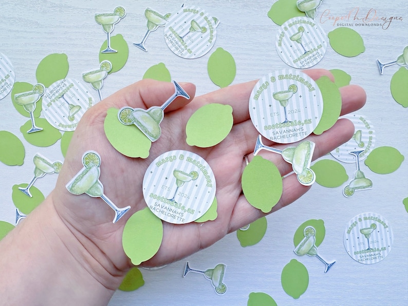 May include: Green and white confetti with a margarita glass and lime design. The confetti says "Margarita & Mayhem" and "Savannah's Bachelorette" with the date "ETS 2024".