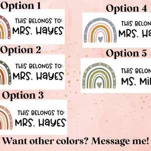 May include: Five different designs for personalized name tags featuring a rainbow with a heart in the center. The text on the tags reads "This belongs to: MRS. HAYES" and "This belongs to: MS. MILLER".