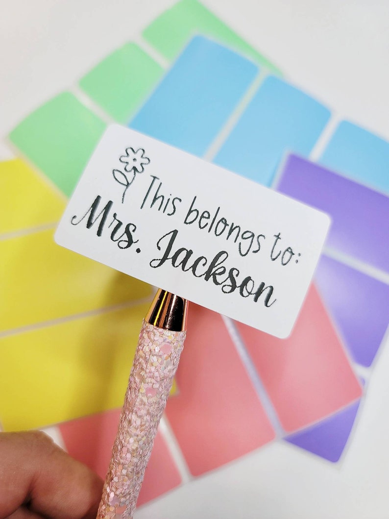 May include: White rectangular sticker with a small flower design and the text "This belongs to: Mrs. Jackson".