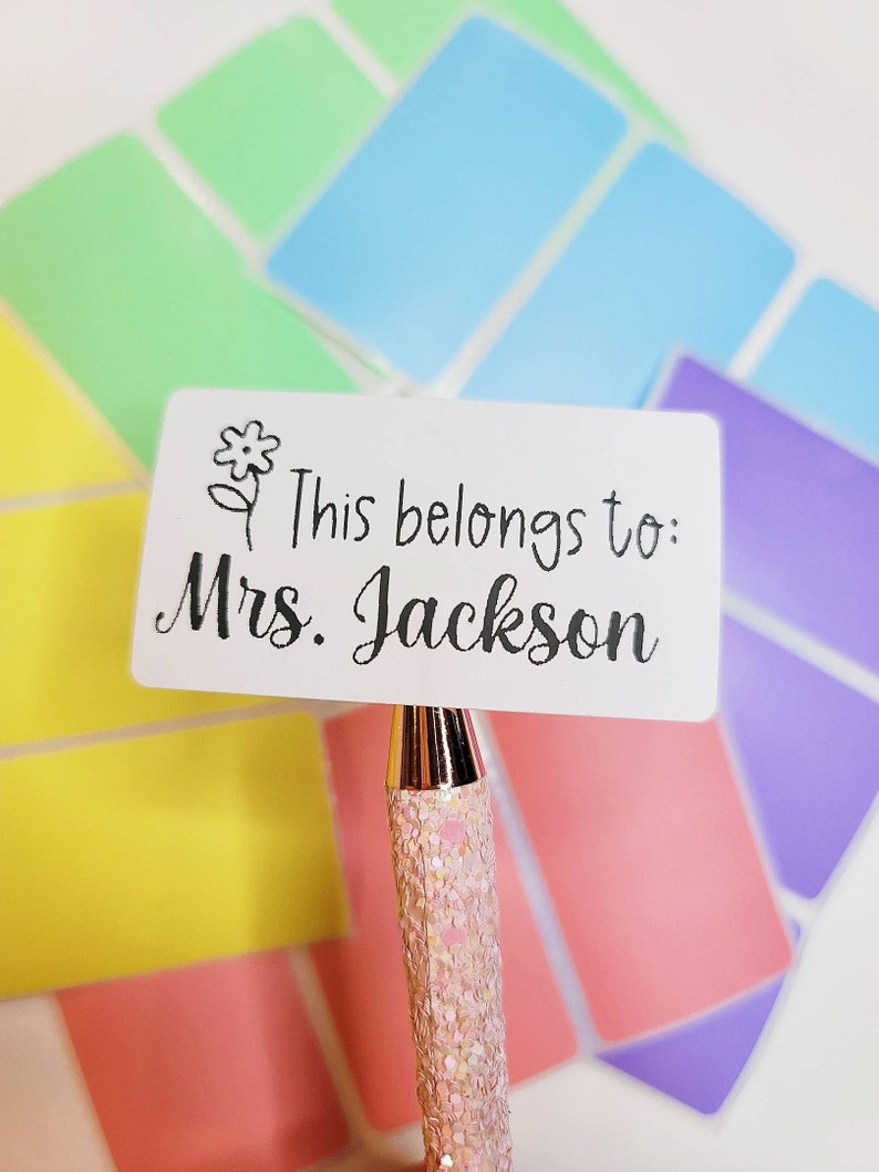 May include: White rectangular sticker with a black flower and the text "This belongs to: Mrs. Jackson".