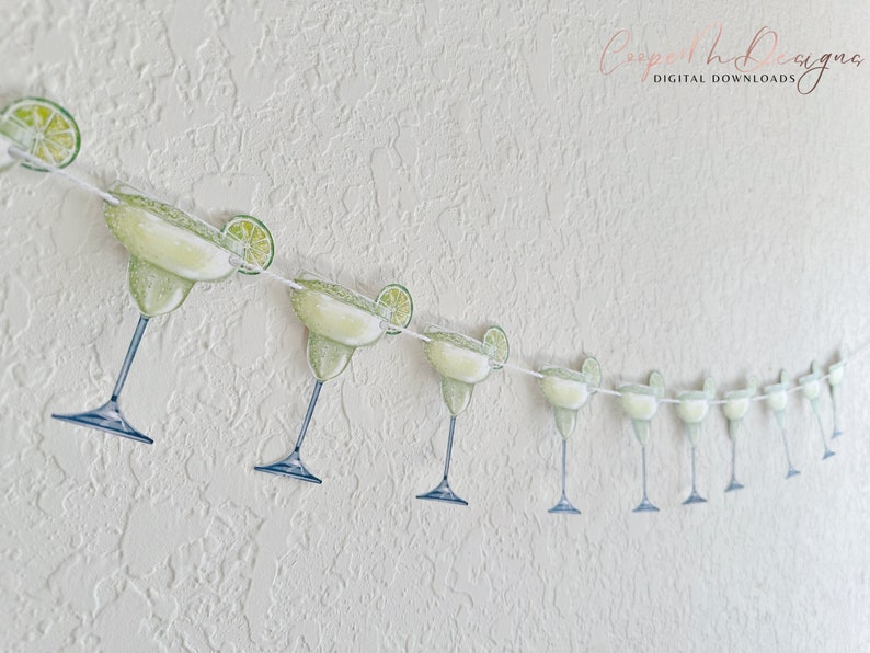 May include: A string of green margarita glasses with lime wedges, perfect for a fiesta or Cinco de Mayo party.