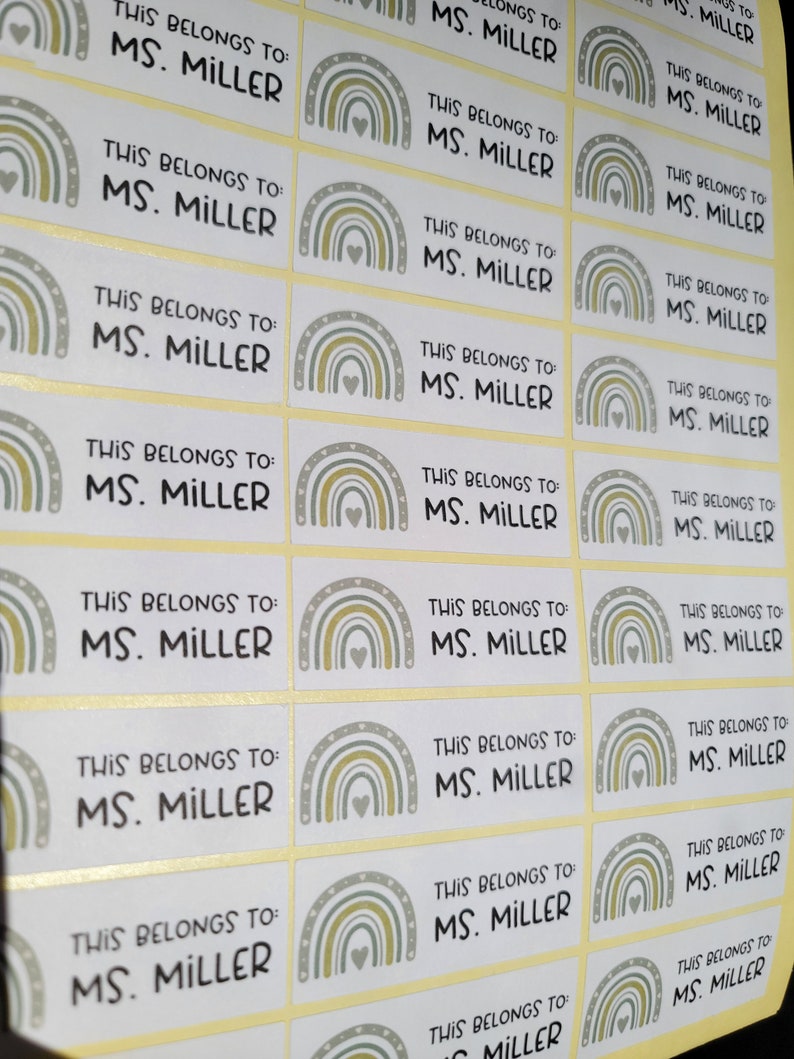 May include: A sheet of 20 colorful rainbow-themed labels with the text "This belongs to: MS. MILLER" repeated on each label.