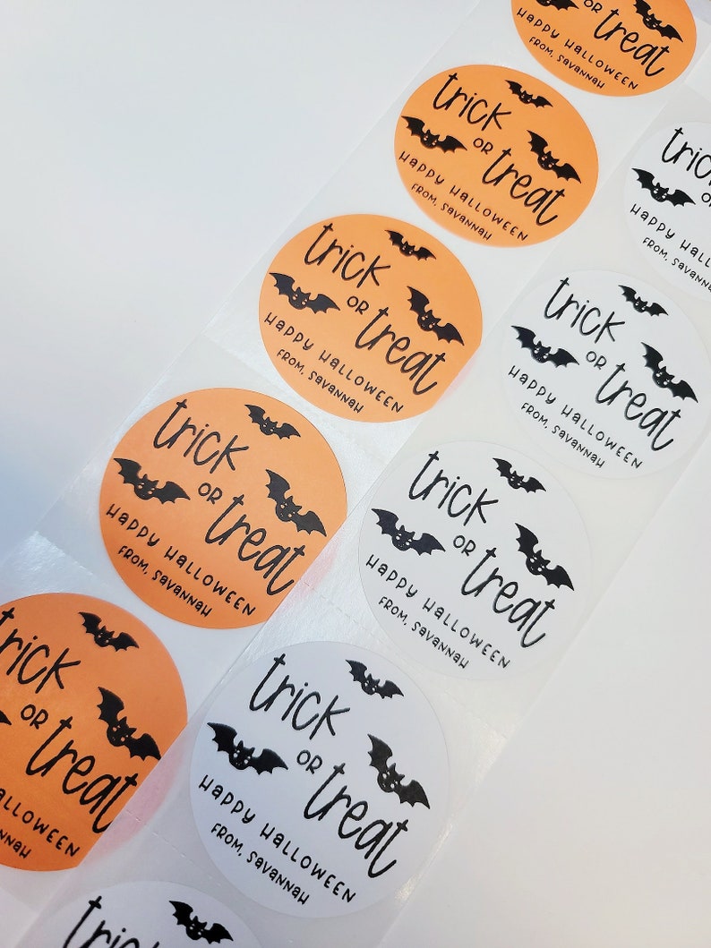 May include: A sheet of orange and white round stickers with the text "trick or treat" and a bat graphic. The text "Happy Halloween from, Savannah" is also included on each sticker.
