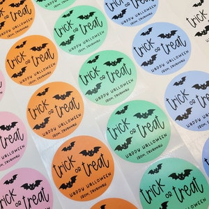 May include: A sheet of colorful round stickers with the text "trick or treat" and "Happy Halloween" with a bat graphic. The stickers are in various colors including orange, pink, blue, and green.