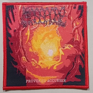 May include: Square, embroidered patch with a red border and a dark background. The patch features a fiery, abstract design in shades of red, orange, and yellow, with the text "PROVOKED ACCURSER" at the bottom. The patch is likely for clothing or accessories.