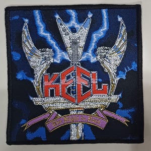 May include: A black and blue embroidered patch with the word "KEEL" in red letters and a silver guitar with wings. The text "The Right to Rock" is on a pink ribbon.