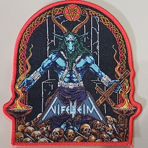 May include: Embroidered patch featuring a blue demonic figure with horns, holding a cross and surrounded by flames and skulls. The patch has a red border and the word "Nifelheim" is displayed in white. The design is detailed and gothic.