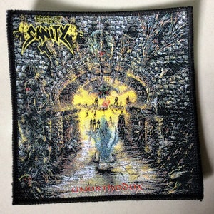 May include: Black and white embroidered patch featuring the band name "Edge of Sanity" and the album title "Unorthodox" in red text. The image depicts a dark, gothic scene with a stone archway and figures in the background.