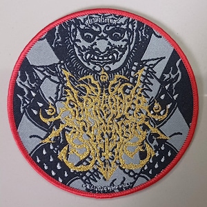 May include: A black and silver embroidered patch with a gold metallic design. The patch features a skull with a crown and the text "WUMP KULT" in a gothic font.
