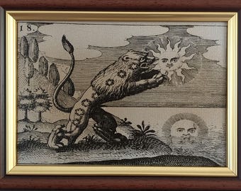 May include: A framed black and white engraving featuring a lion with star markings on its body, standing on a landscape with trees. A sun with a human face is in the sky, and a second sun-like face appears in the water. The number 18 is visible.
